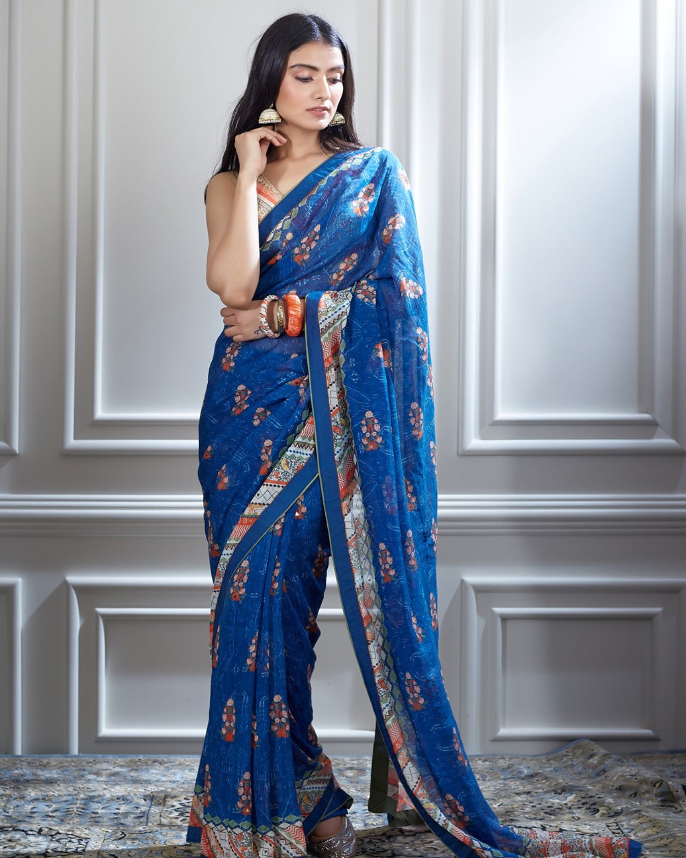 A printed saree paired with a printed and hand heigh lighted blouse.