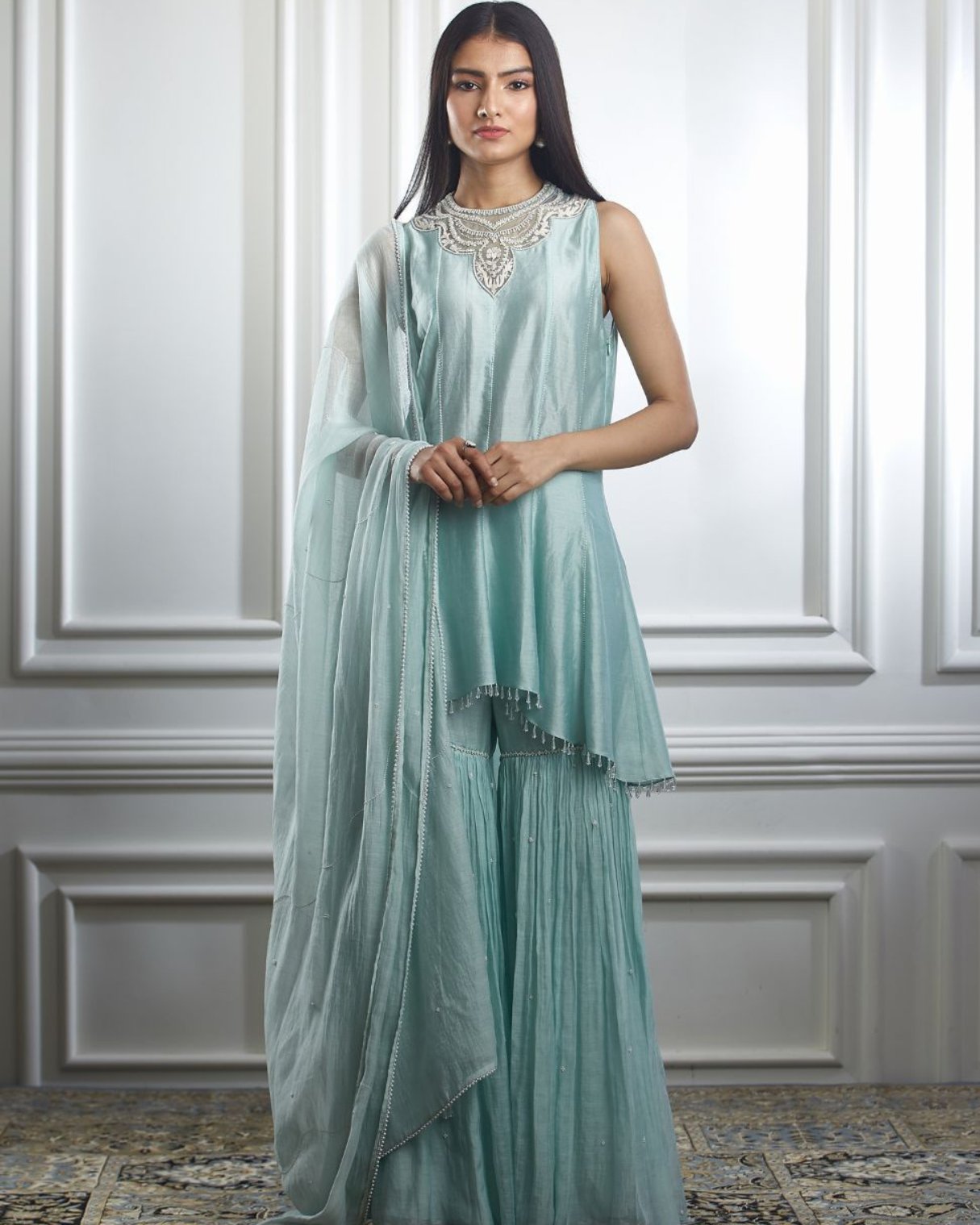 Soft aqua hand embroidered high low kurta Paired with sharara and dupatta