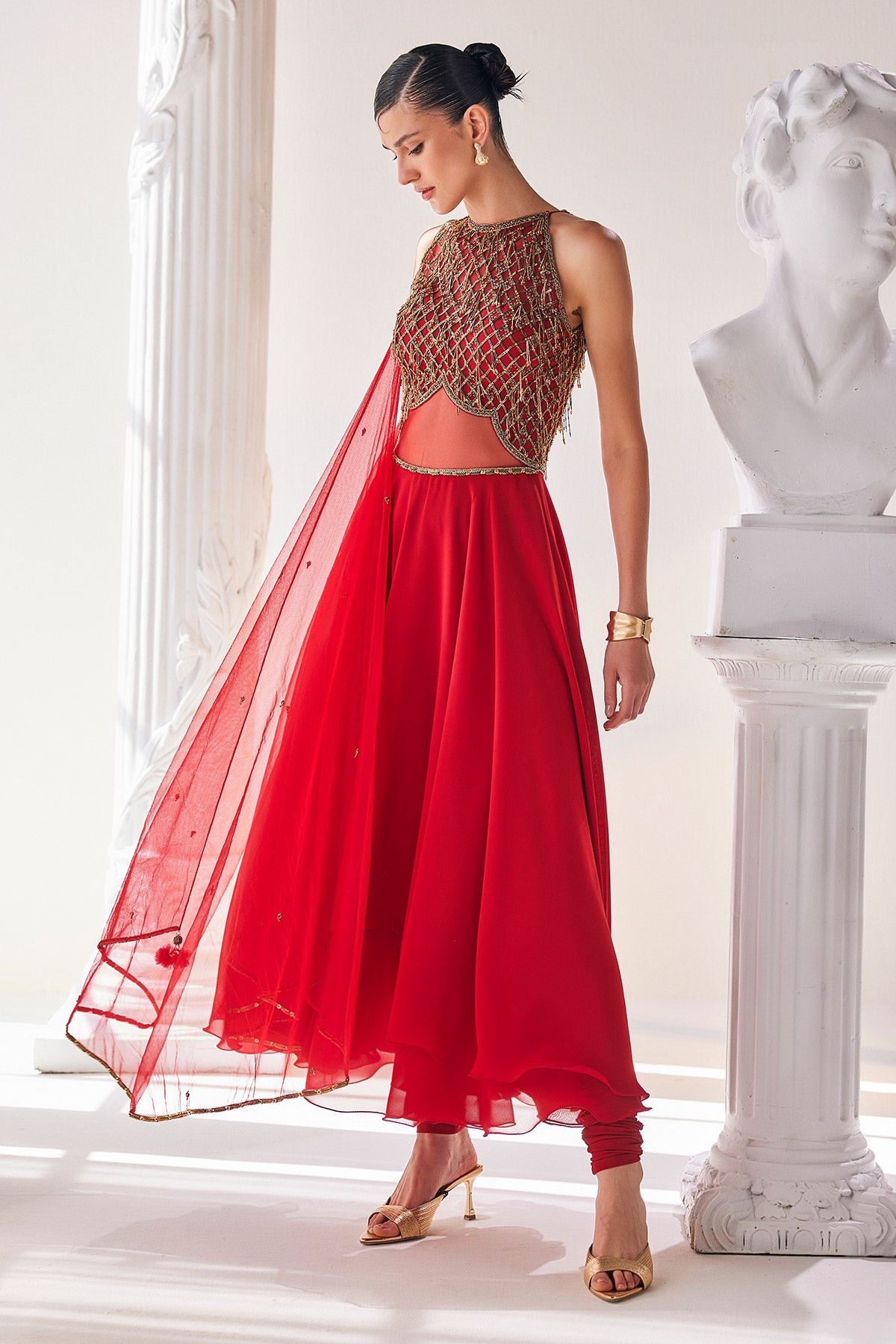 Red Georgette High Low Anarkali Designed With An Emroidered Bodice Paired With A Churidar And A Net Dupatta.