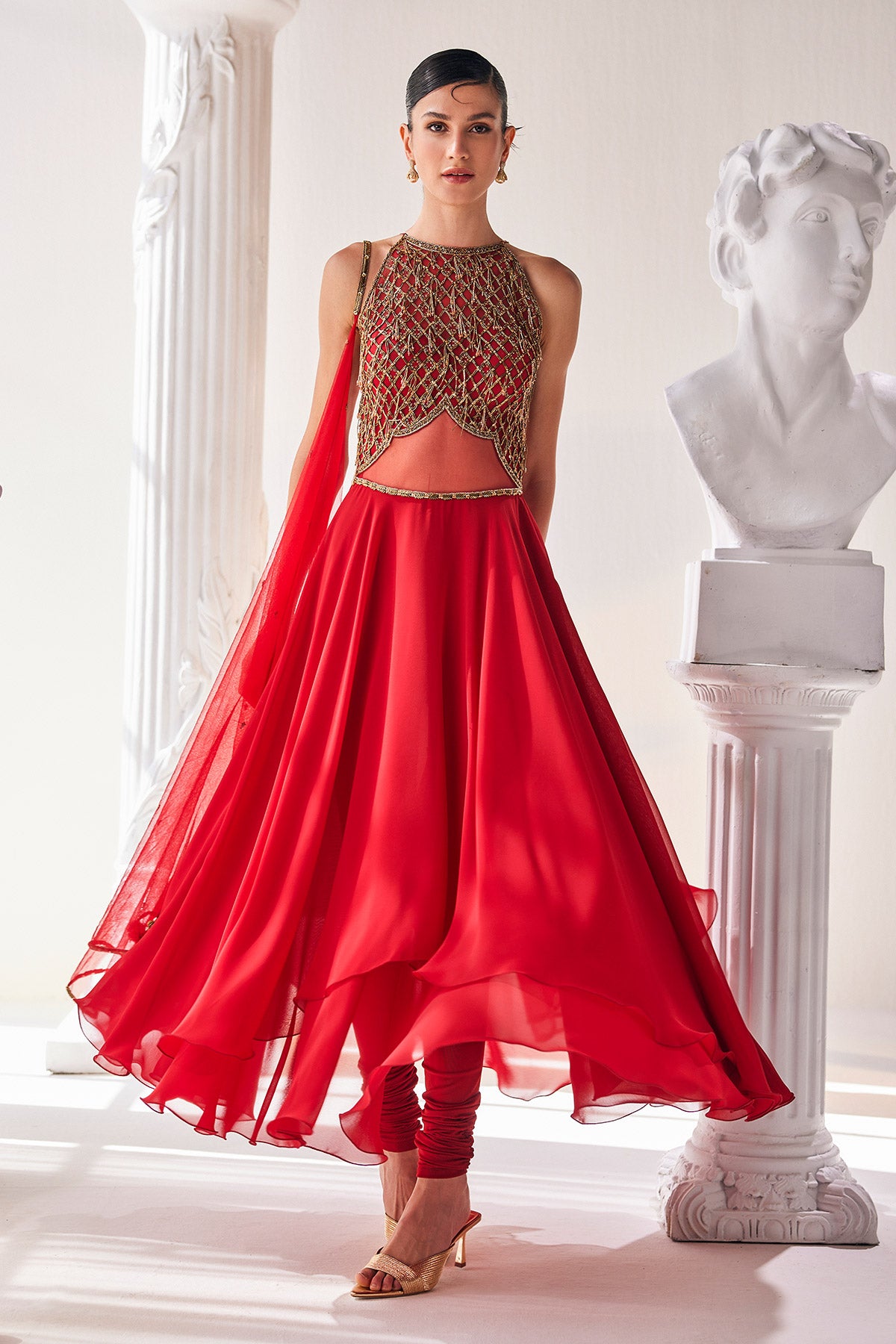 Red Georgette High Low Anarkali Designed With An Emroidered Bodice Paired With A Churidar And A Net Dupatta.