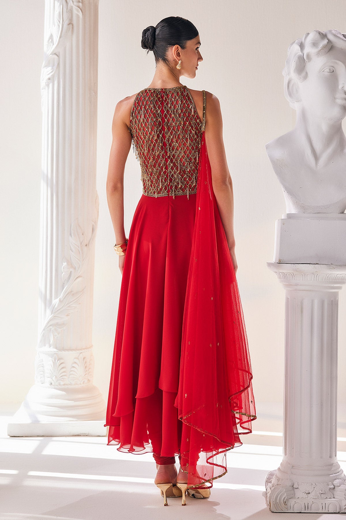 Red Georgette High Low Anarkali Designed With An Emroidered Bodice Paired With A Churidar And A Net Dupatta.