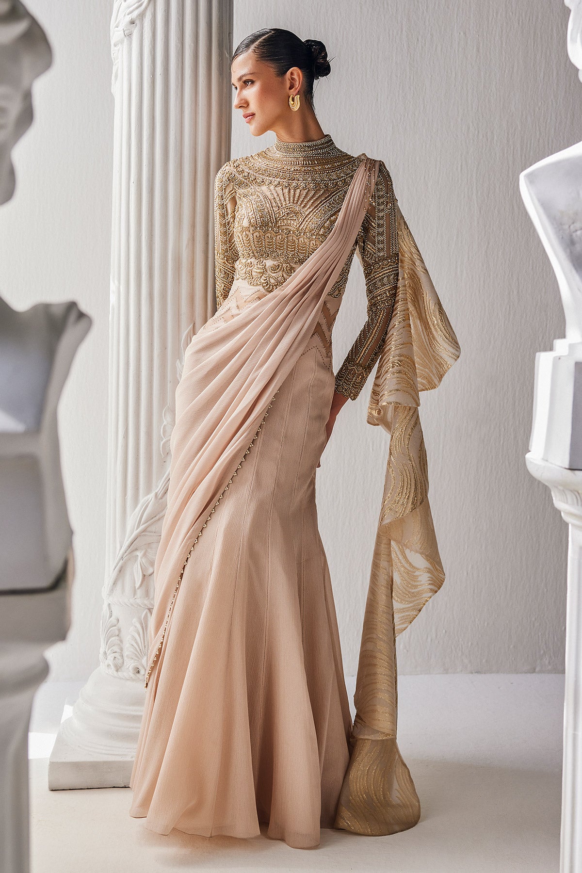 Golden Cream Draped Saree In Luxurious Shimmer Chiffon Offset With A Zardozi Blouse And An Elaborate High Neckline.