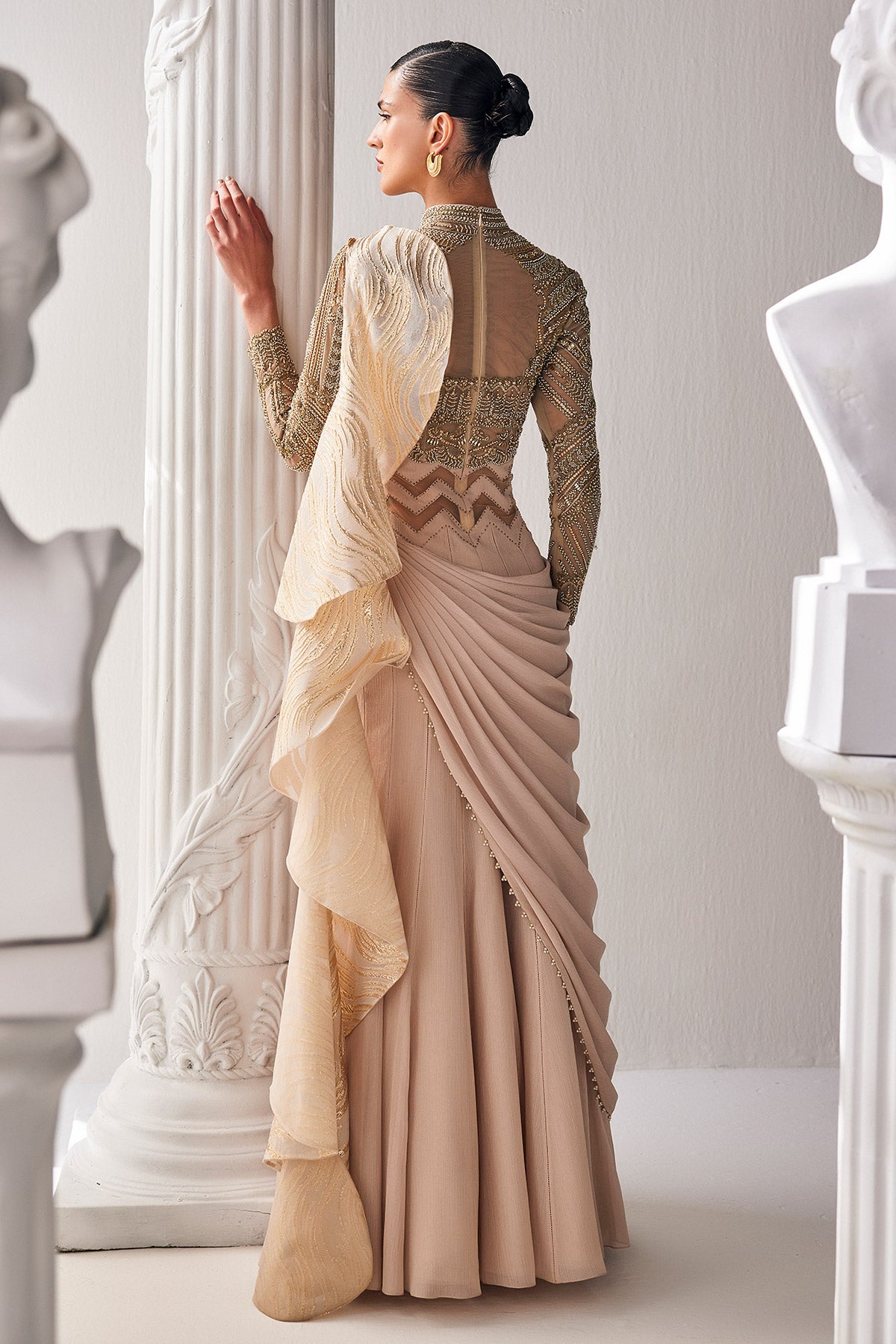 Golden Cream Draped Saree In Luxurious Shimmer Chiffon Offset With A Zardozi Blouse And An Elaborate High Neckline.