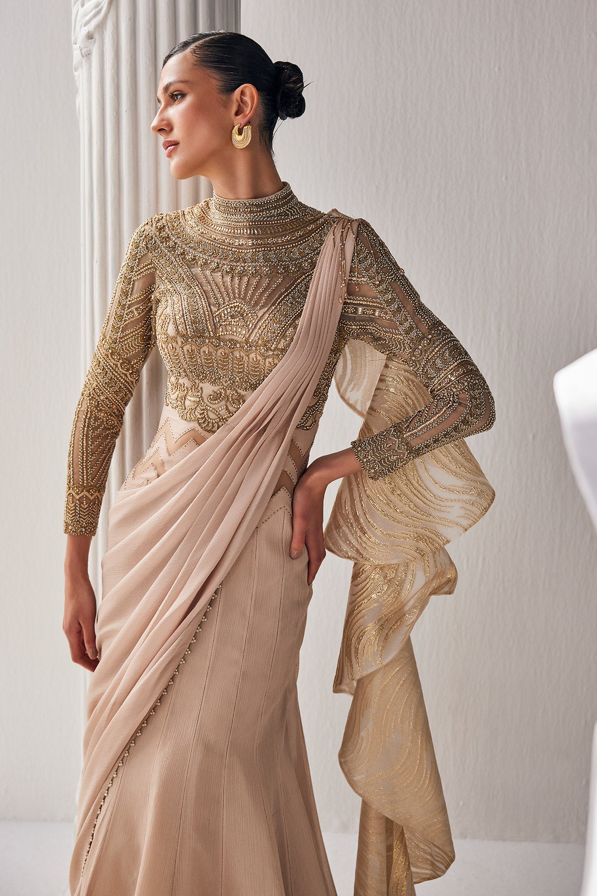 Golden Cream Draped Saree In Luxurious Shimmer Chiffon Offset With A Zardozi Blouse And An Elaborate High Neckline.