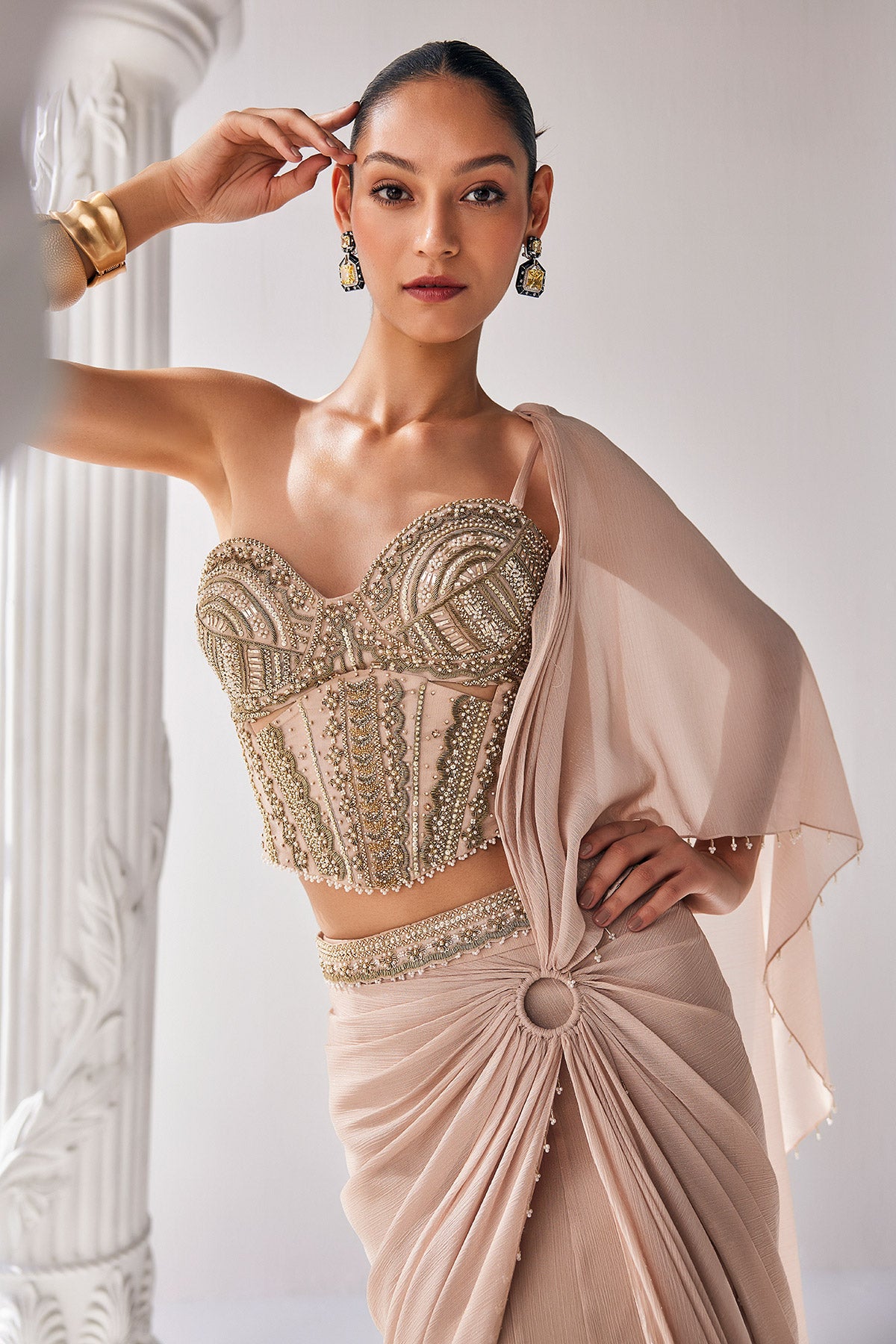 Draped Saree In Metallic Shimmer Chiffon Fabric With Intricate Embroidery Detail In The Corset Along With An Embroiderd Belt.