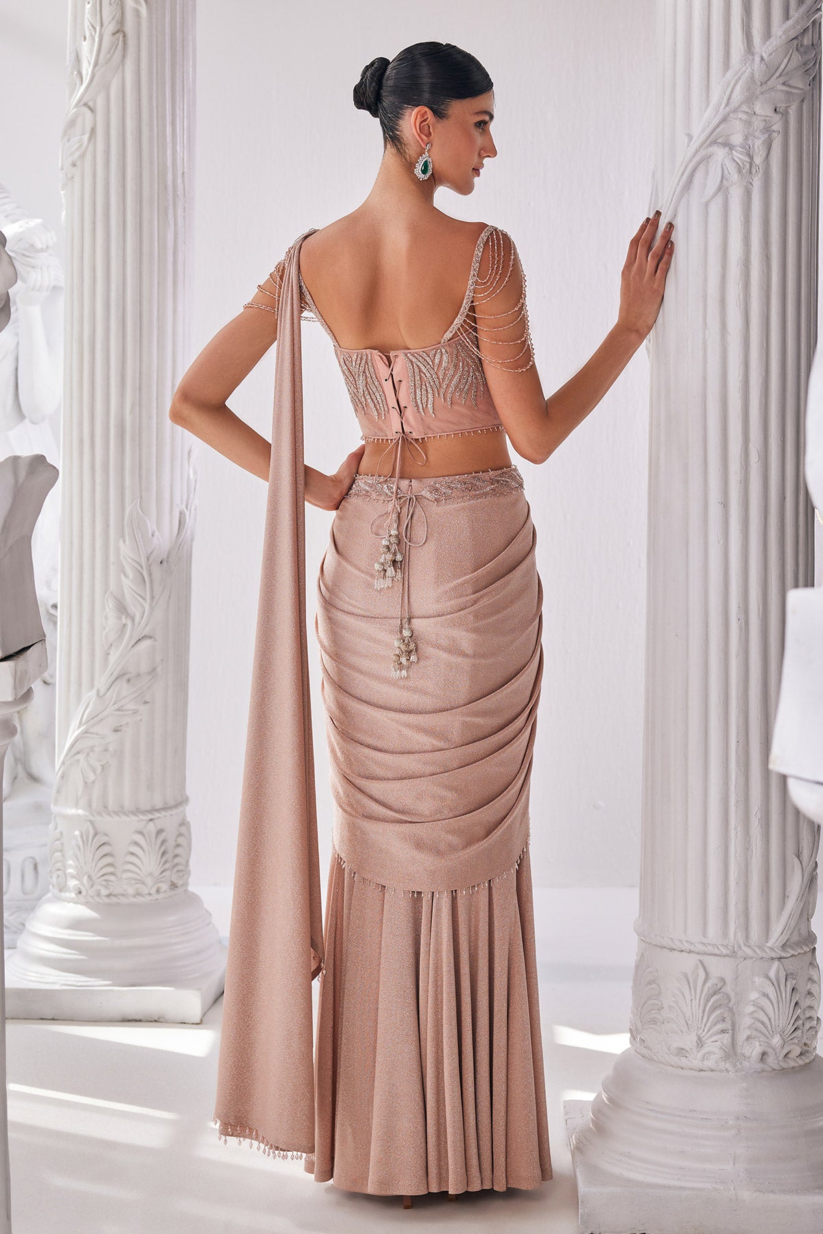 Peach Draped Saree In Luxurious Shimmer Lyrcra. It Is Paired With Anembroidered Corset Blouse And Highlighted With A Statement Belt.