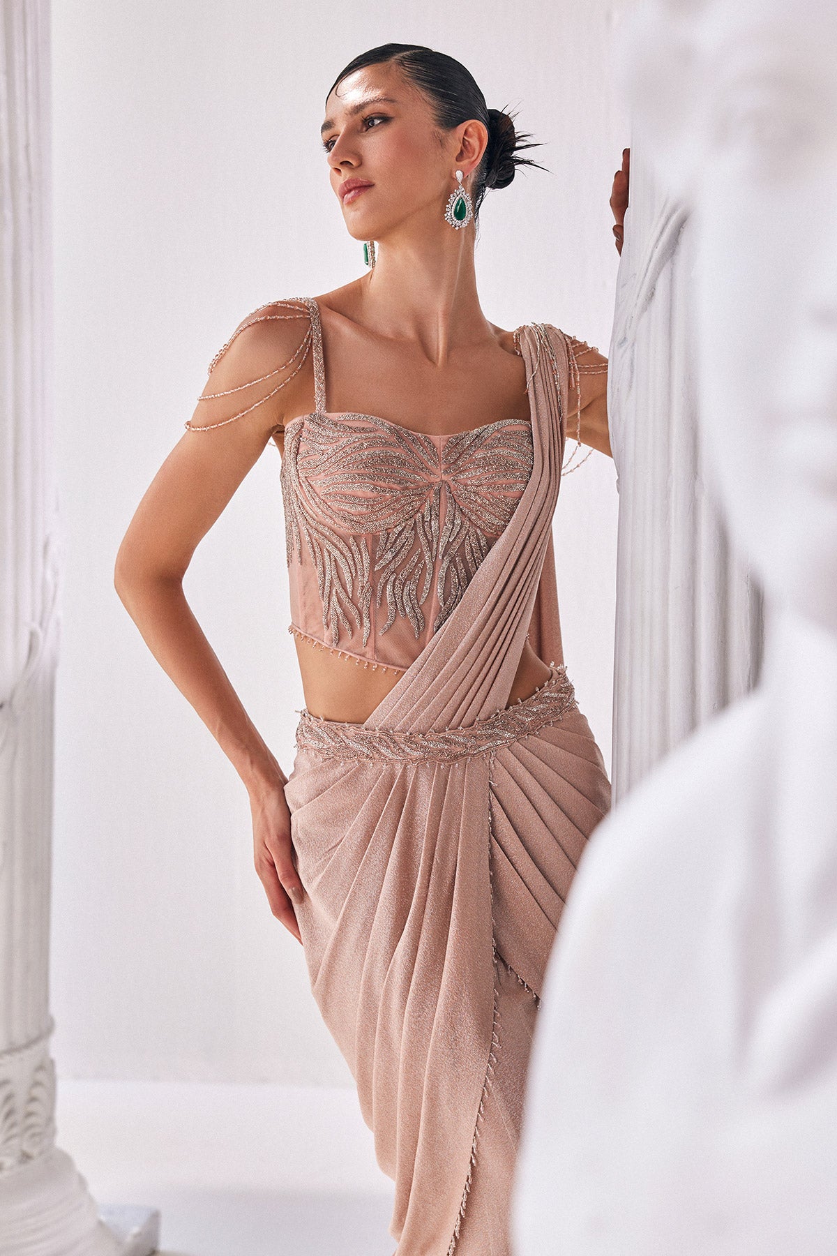 Peach Draped Saree In Luxurious Shimmer Lyrcra. It Is Paired With Anembroidered Corset Blouse And Highlighted With A Statement Belt.