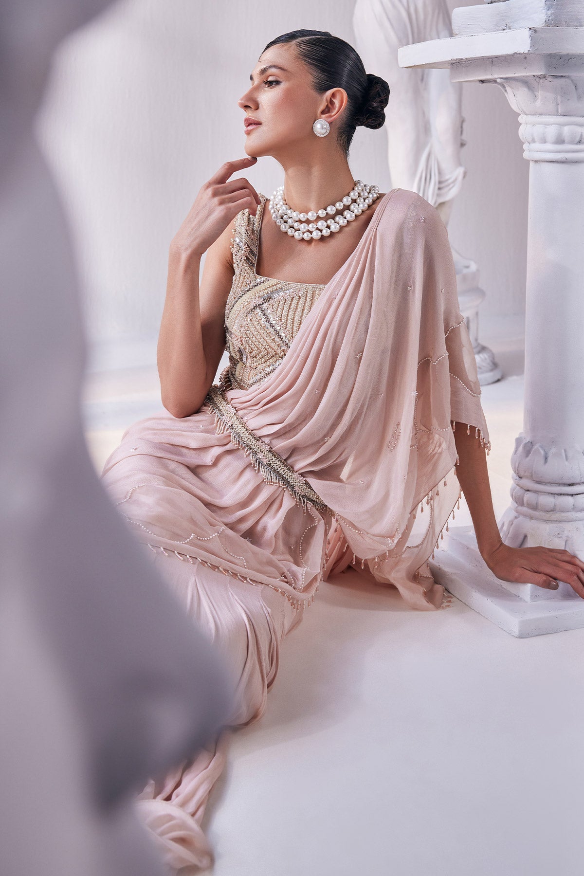 Peach Chiffon Drape Saree With Bead Work Detail Paired With A Heavy Emroidered Blouse And A Belt.