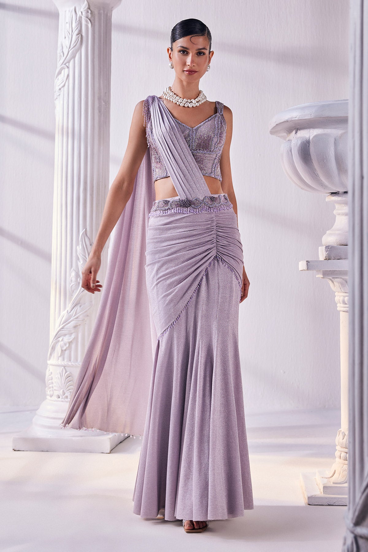 Draped Saree In Luxurious Shimmer Lycra Designed In Lilac Colour, An Emroidered Corset And A Belt.