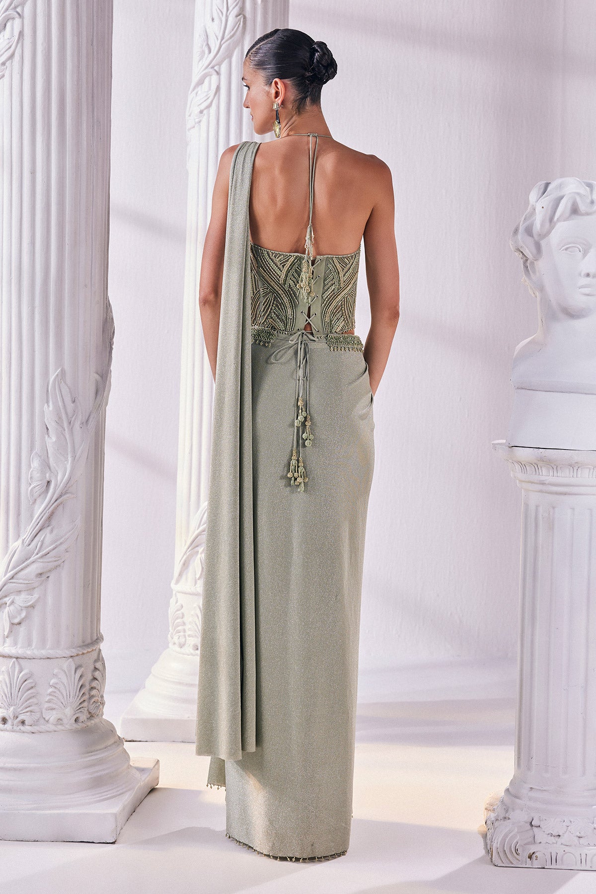 Jade Green Draped Saree In Luxurious Shimmer Lycra Paired With Anemroidered Corset And A Belt.