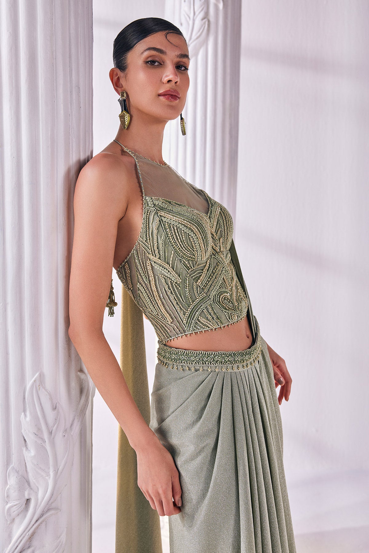 Jade Green Draped Saree In Luxurious Shimmer Lycra Paired With Anemroidered Corset And A Belt.