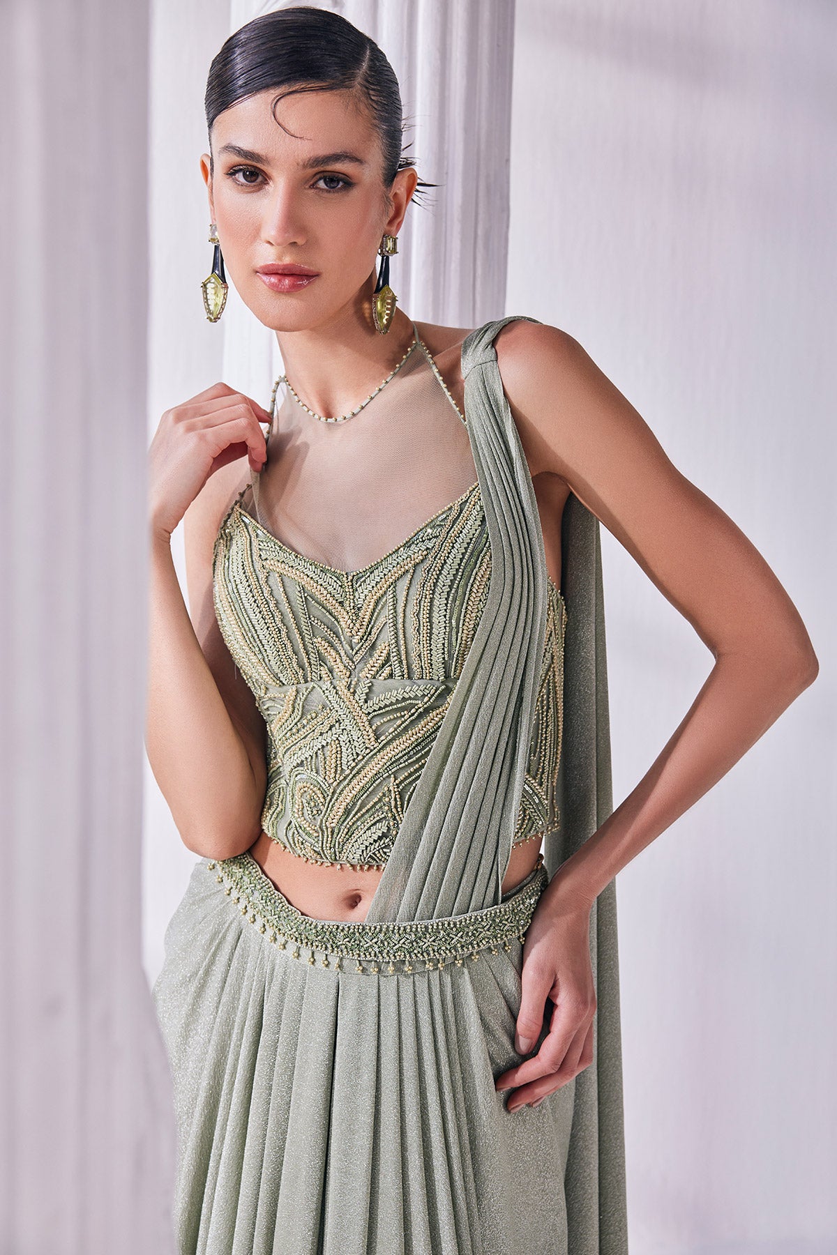 Jade Green Draped Saree In Luxurious Shimmer Lycra Paired With Anemroidered Corset And A Belt.