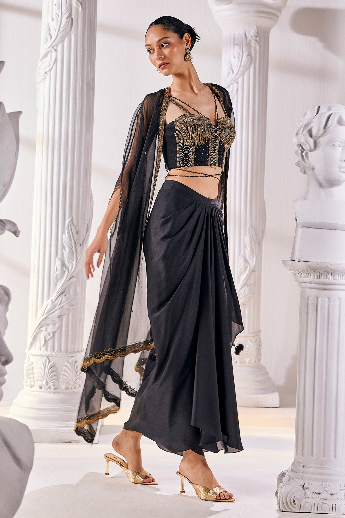 Draped Skirt Paired With An Embroidered Corset Blouse, Cape And A Belt.