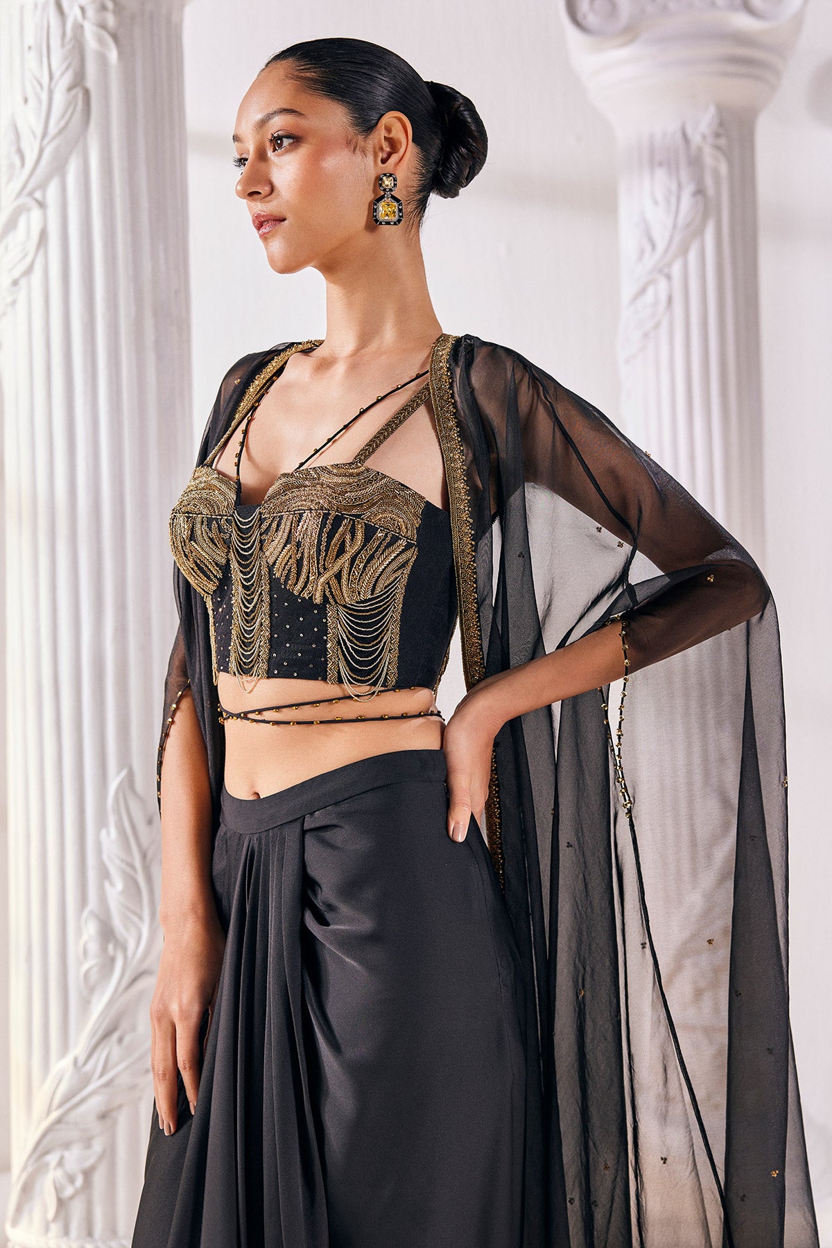 Draped Skirt Paired With An Embroidered Corset Blouse, Cape And A Belt.