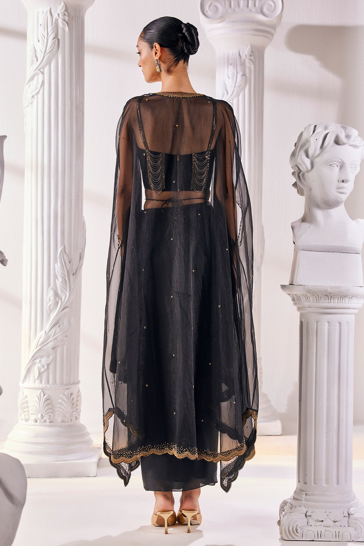 Draped Skirt Paired With An Embroidered Corset Blouse, Cape And A Belt.