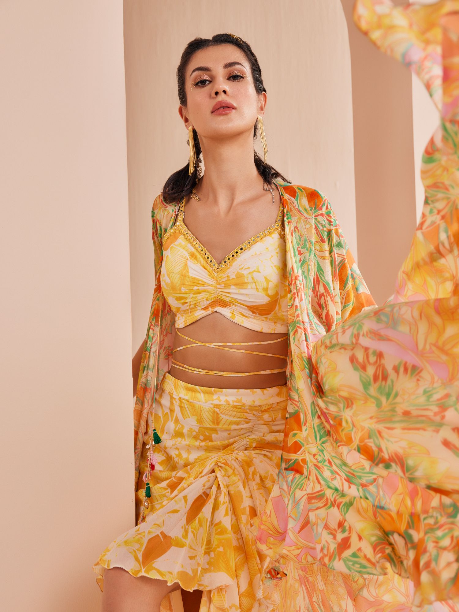 Fluorescent yellow printed blouse with draped asymmetric chiffon skirt stylized with a cape