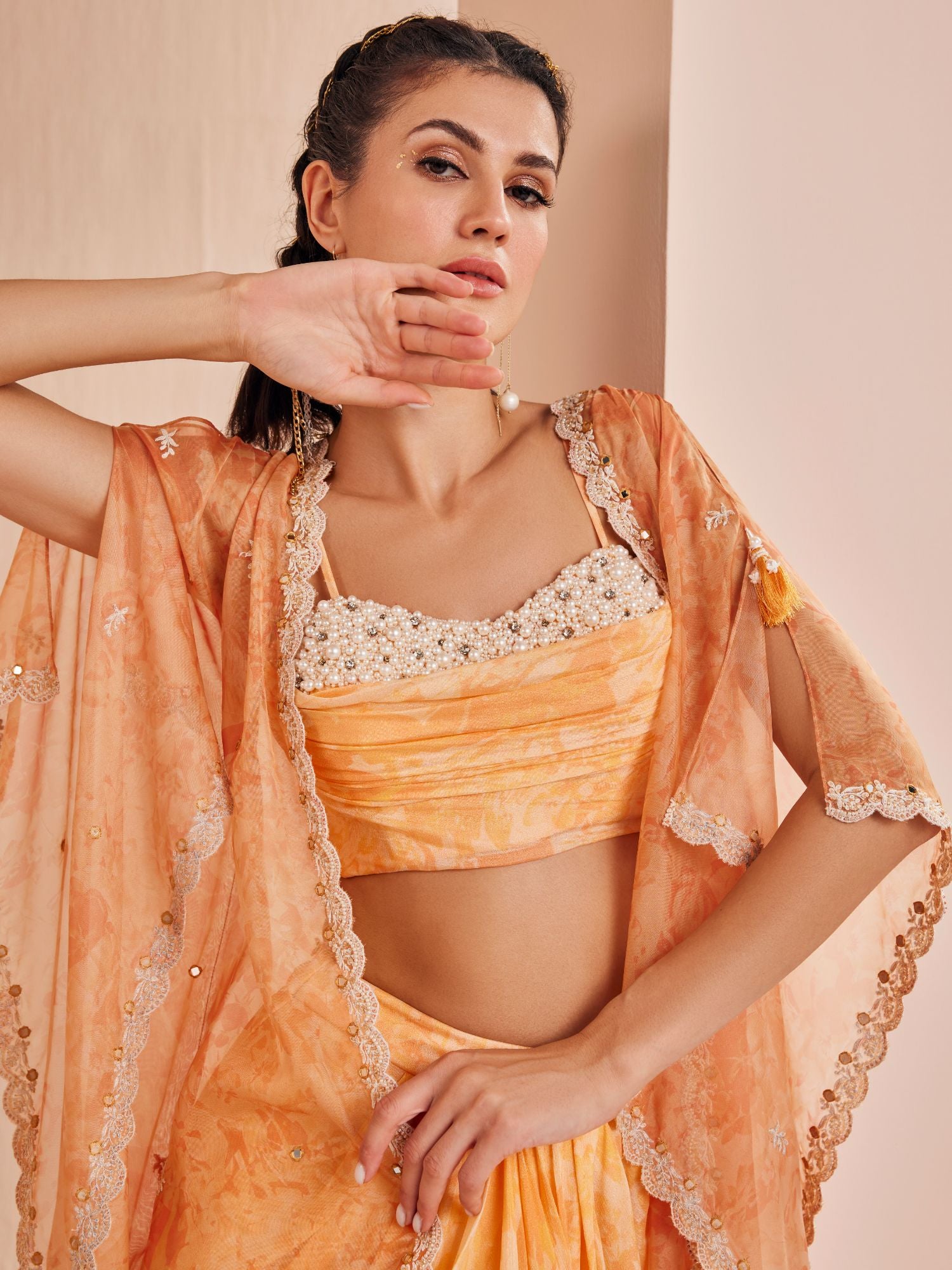 Orange pancy daisy bustier paired with skirt and cape