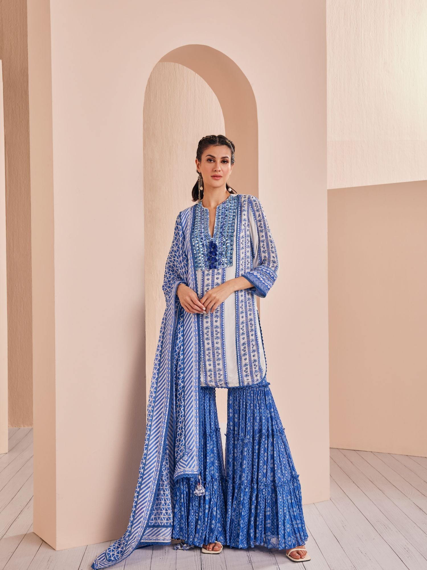 Blue perwinkle border kurta paired with tiered sharara and dupatta