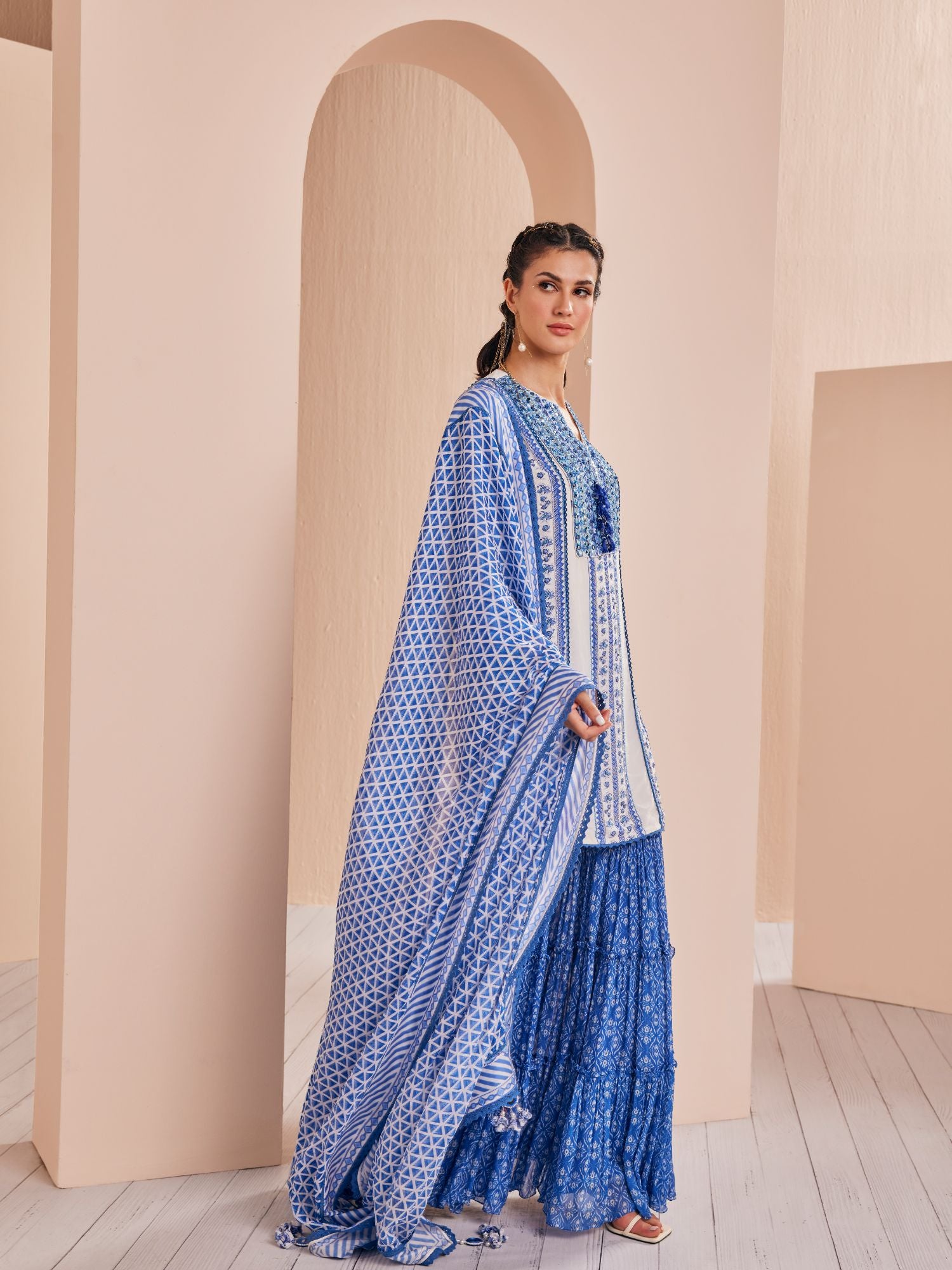 Blue perwinkle border kurta paired with tiered sharara and dupatta