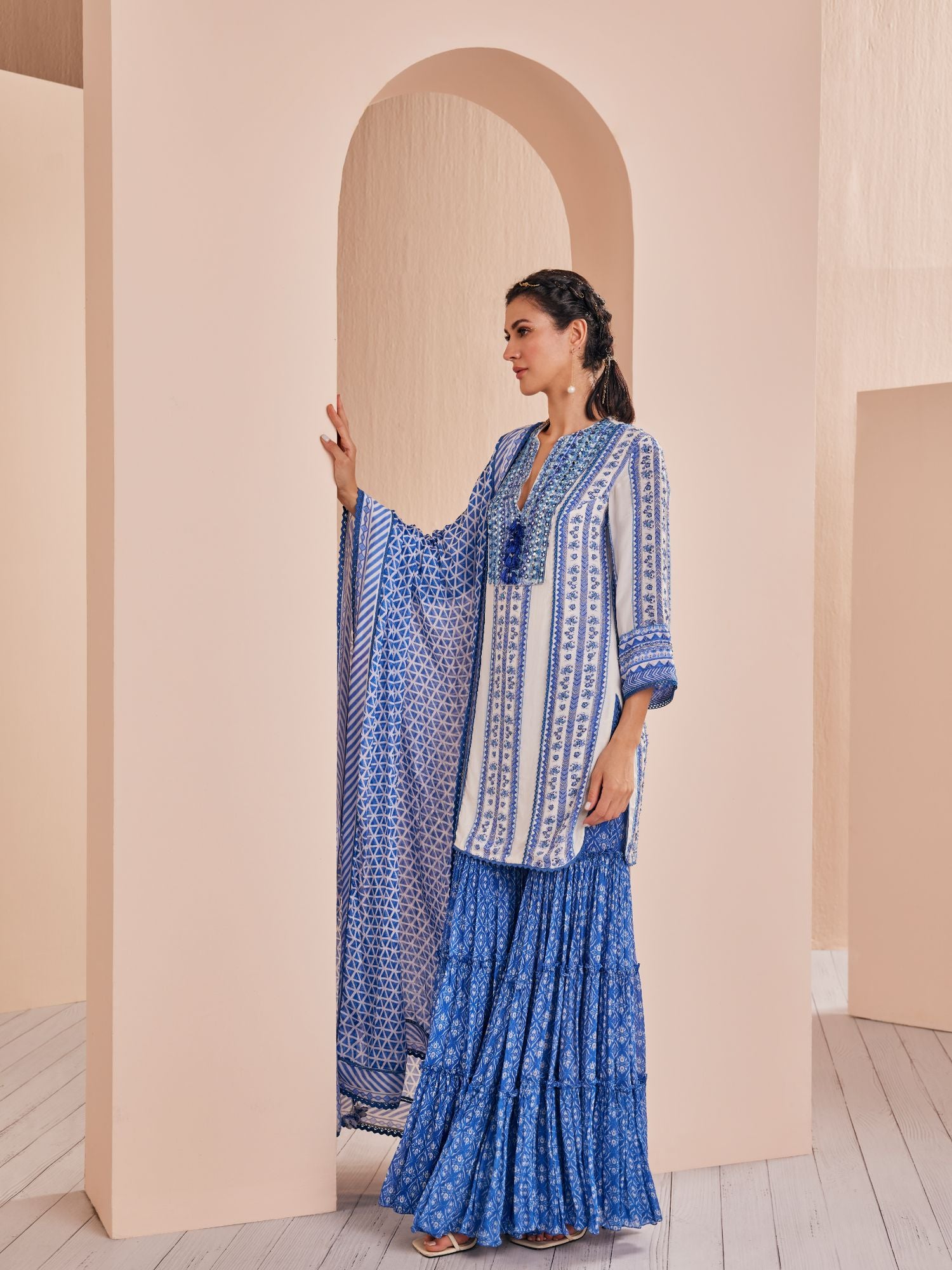 Blue perwinkle border kurta paired with tiered sharara and dupatta