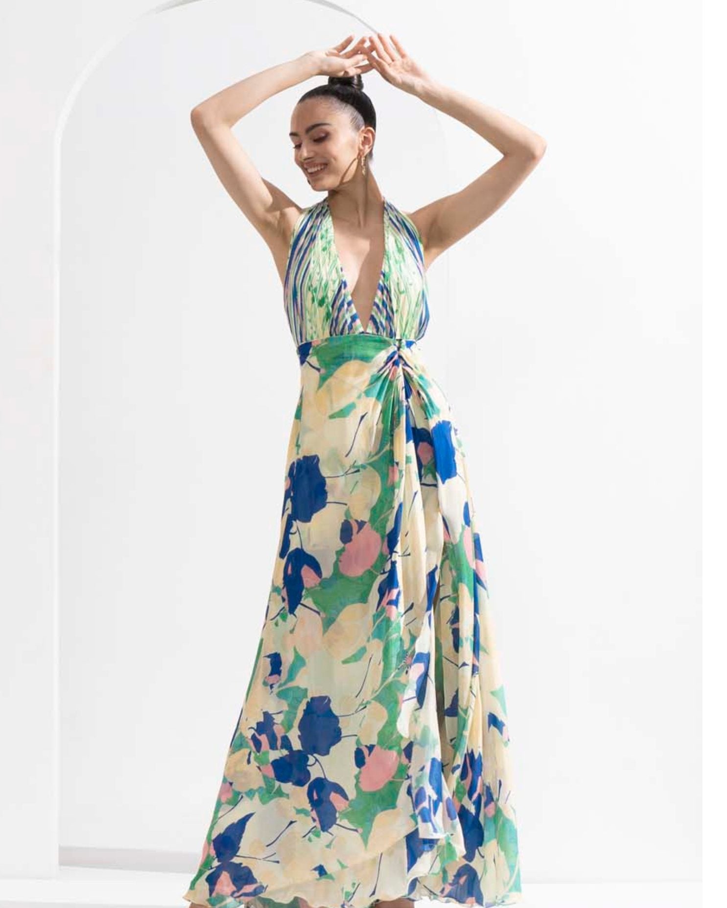 Mystic green chiffon placement printed draped halter neck dress with a silver accessory.