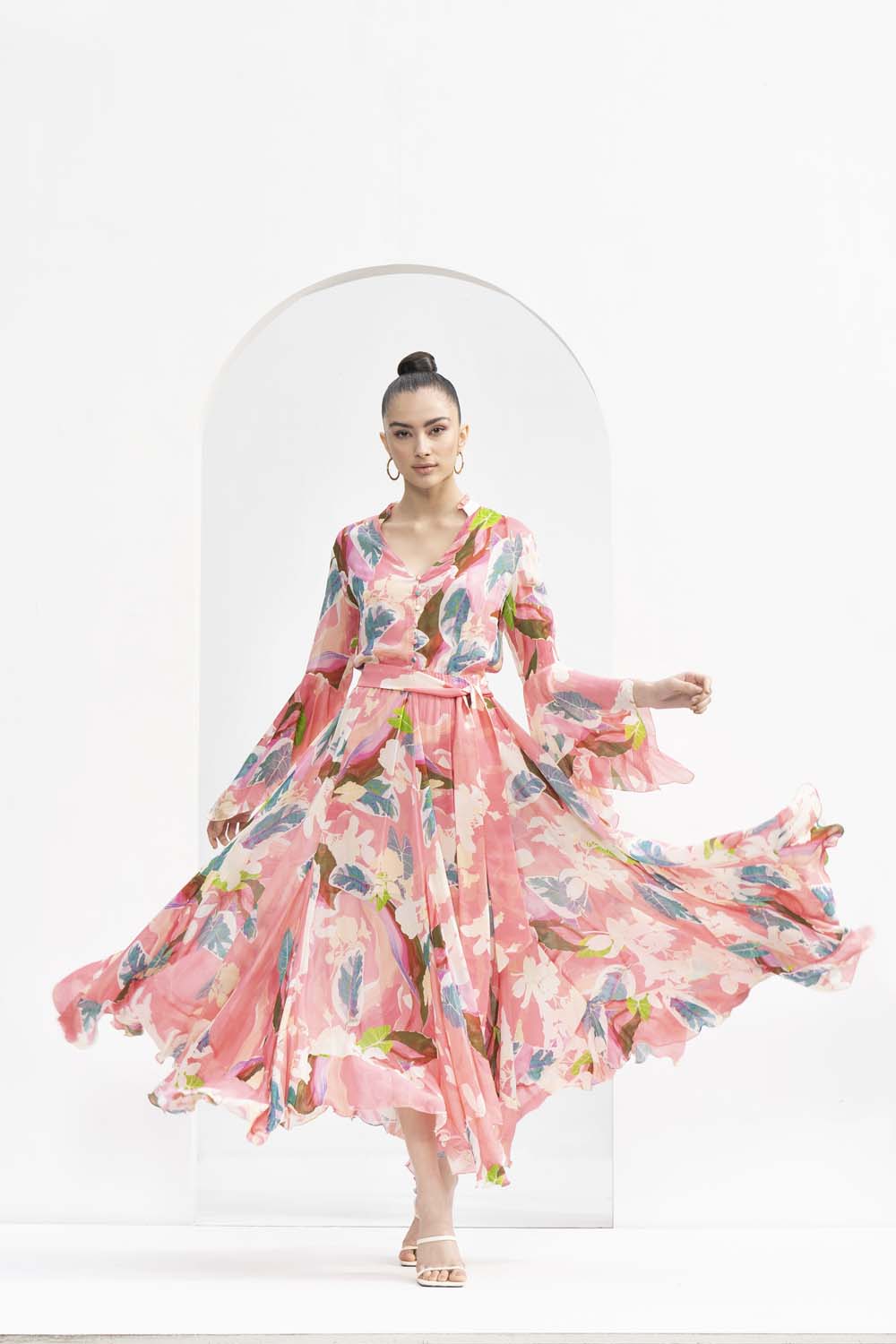 Peach tropical printed chiffon dress with godets and ruffled details on the neckline.