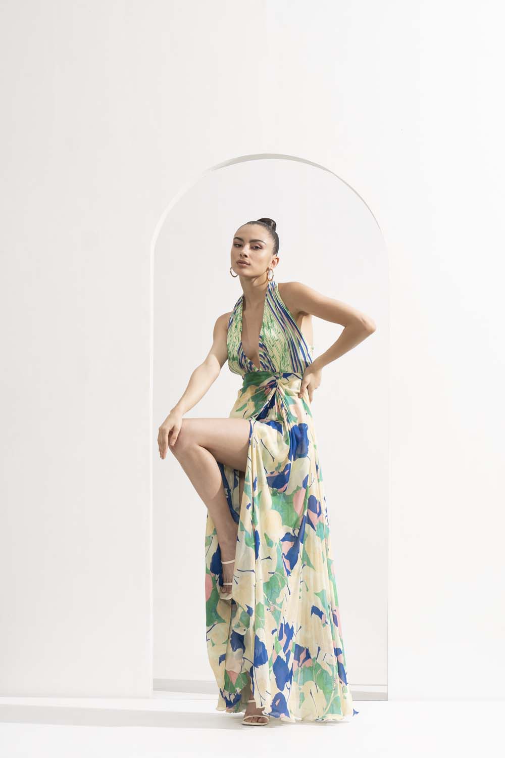 Mystic green chiffon placement printed draped halter neck dress with a silver accessory.