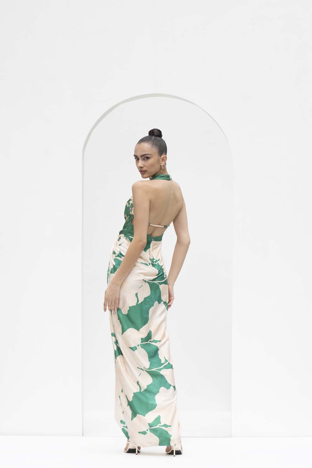 Mystic green placement printed draped halter neck dress made with lustrous satin.
