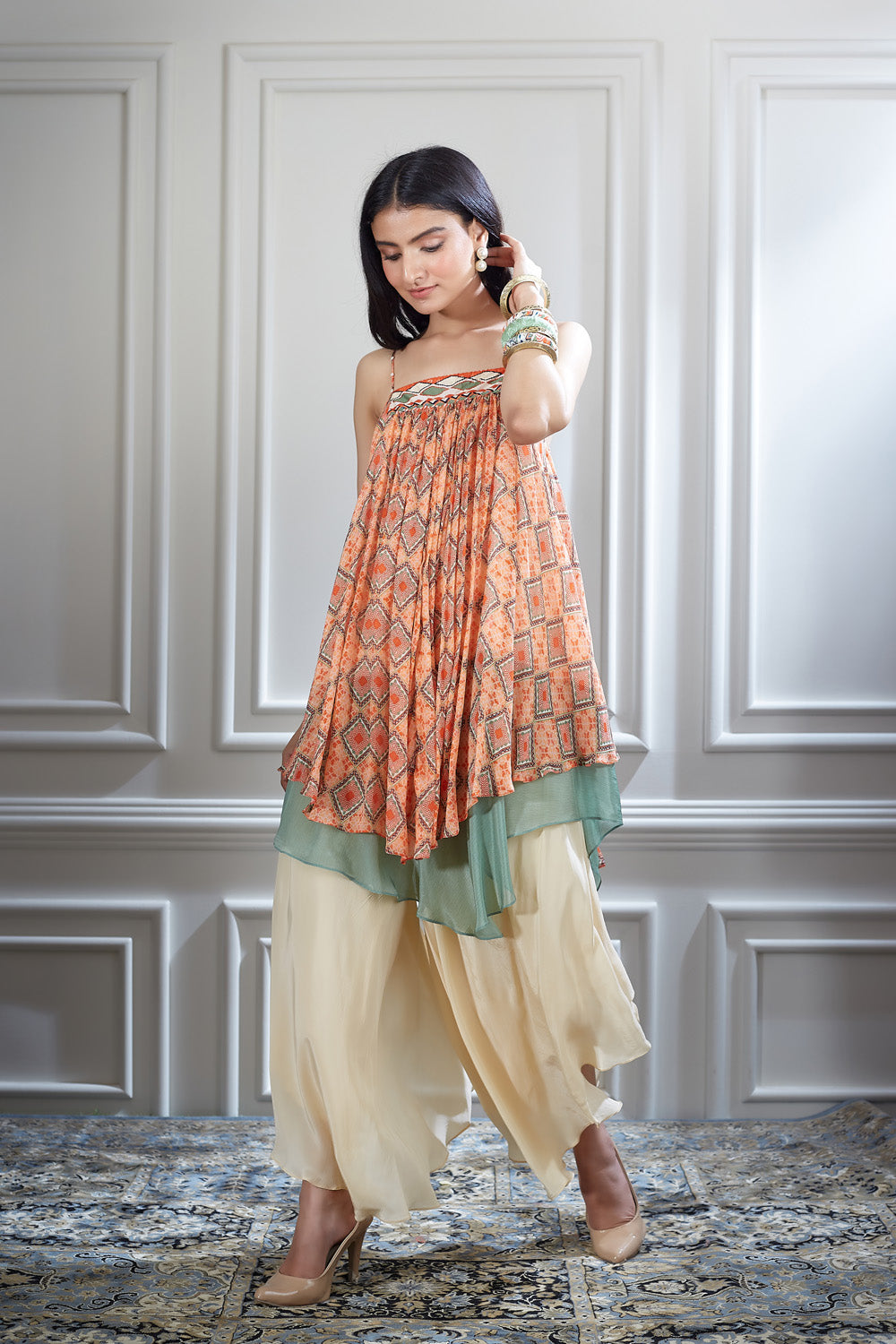 A printed chiffon asymmetrical layer top paired with an ivory layered sharara