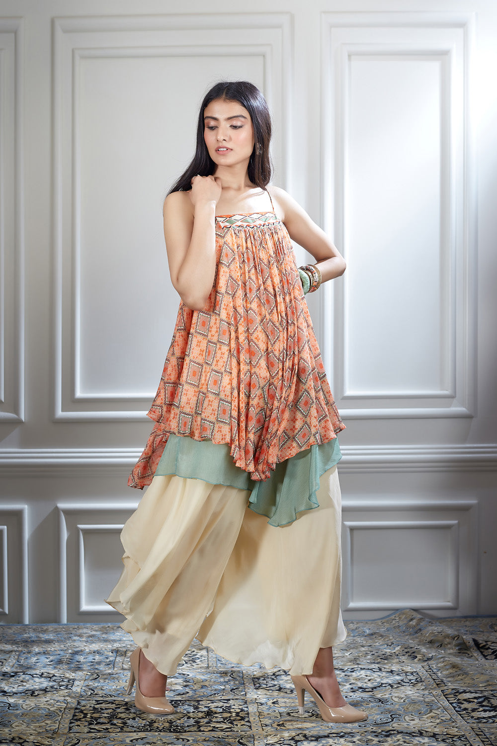 A printed chiffon asymmetrical layer top paired with an ivory layered sharara