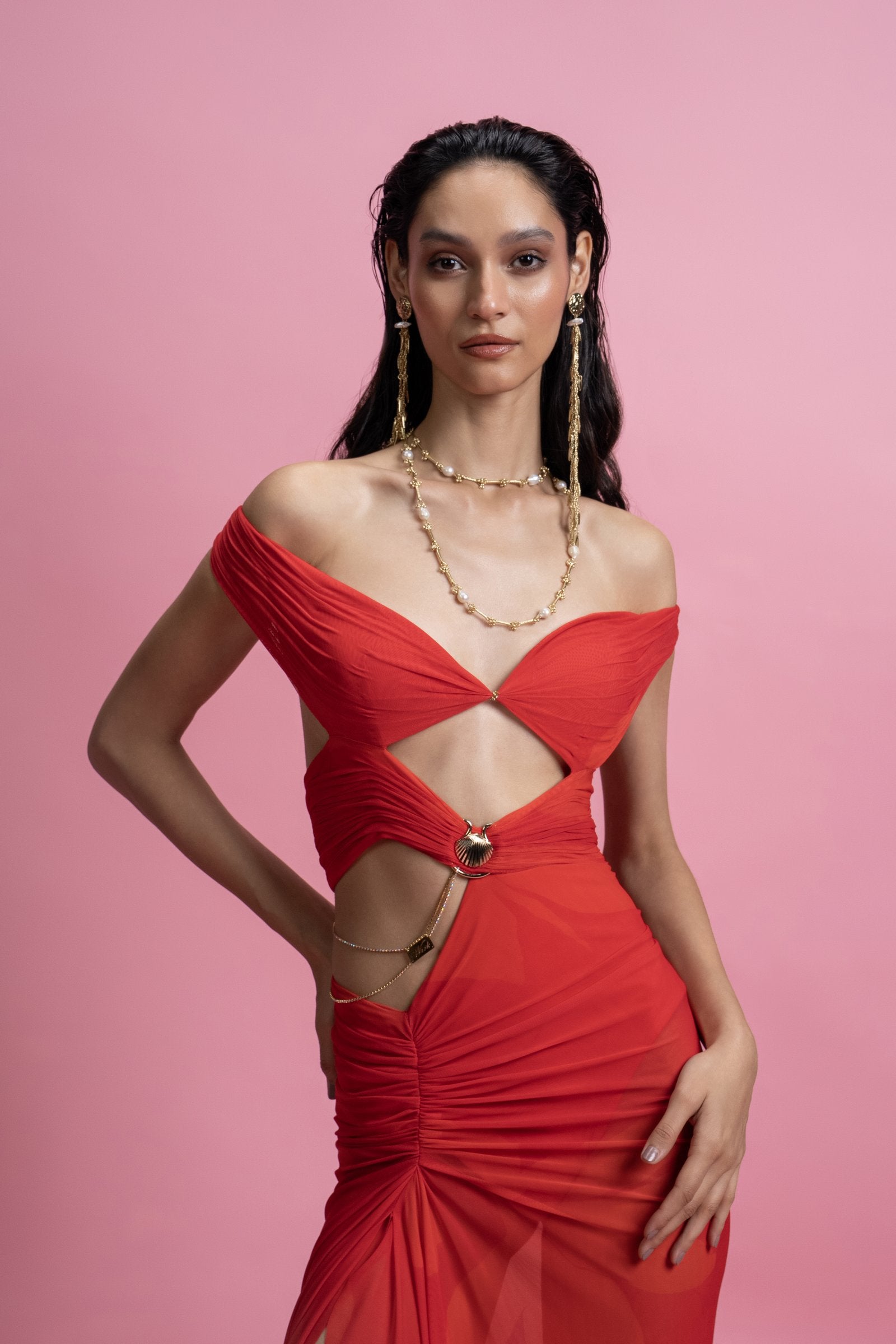An off-shoulder gown constructed over a built-in bodysuit, 