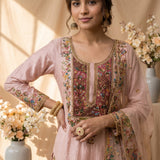 This blush pink kurta set celebrates the beauty of traditional resham embroidery in a fresh, contemporary form. Multicoloured floral motifs are intricately embroidered along the neckline and front, creating a striking focal point