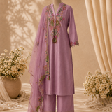 A lavender purple three-piece salwar kameez suit set with floral embroidery, displayed on a black mannequin. The set includes a long-sleeve kurta, matching trousers, and a sheer dupatta draped over the shoulder.