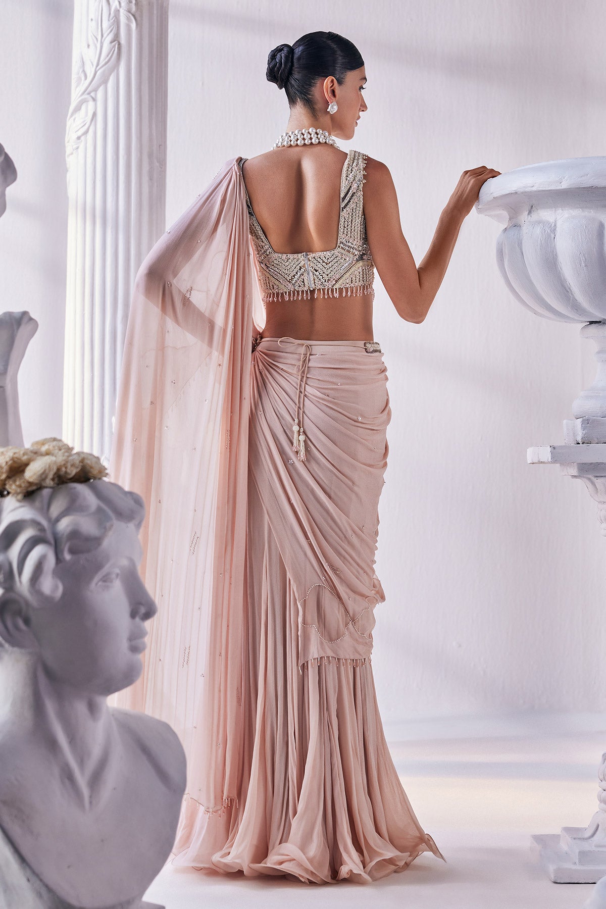 Peach Chiffon Drape Saree With Bead Work Detail Paired With A Heavy Emroidered Blouse And A Belt.