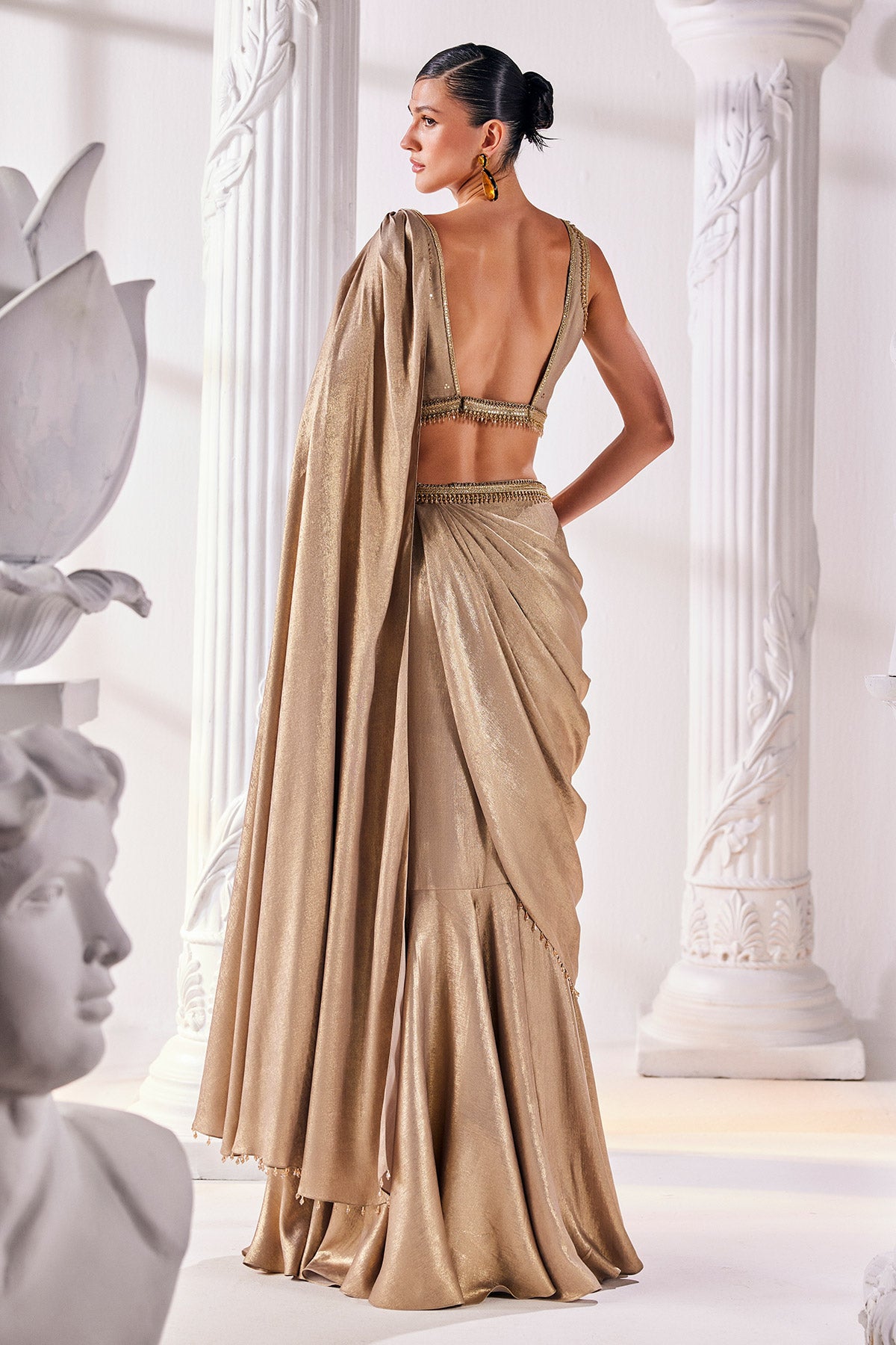 Mettalic Antique Gold Drape Saree With An Embellished Belt. It Is Paired With A Luxurious Metallic Blouse.