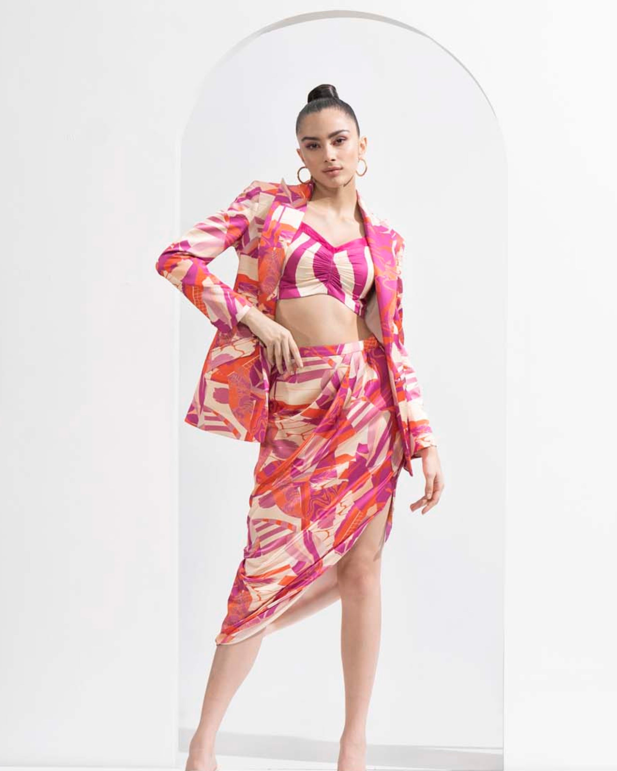 Fuchsia abstract printed blazer & fuchsia waves printed bustier with draped skirt.