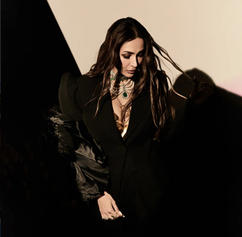 Malaika Arora wearing a black statement blazer with sculpted shoulders and dramatic sleeves from the Mandira Wirk Celebrity Closet Collection.