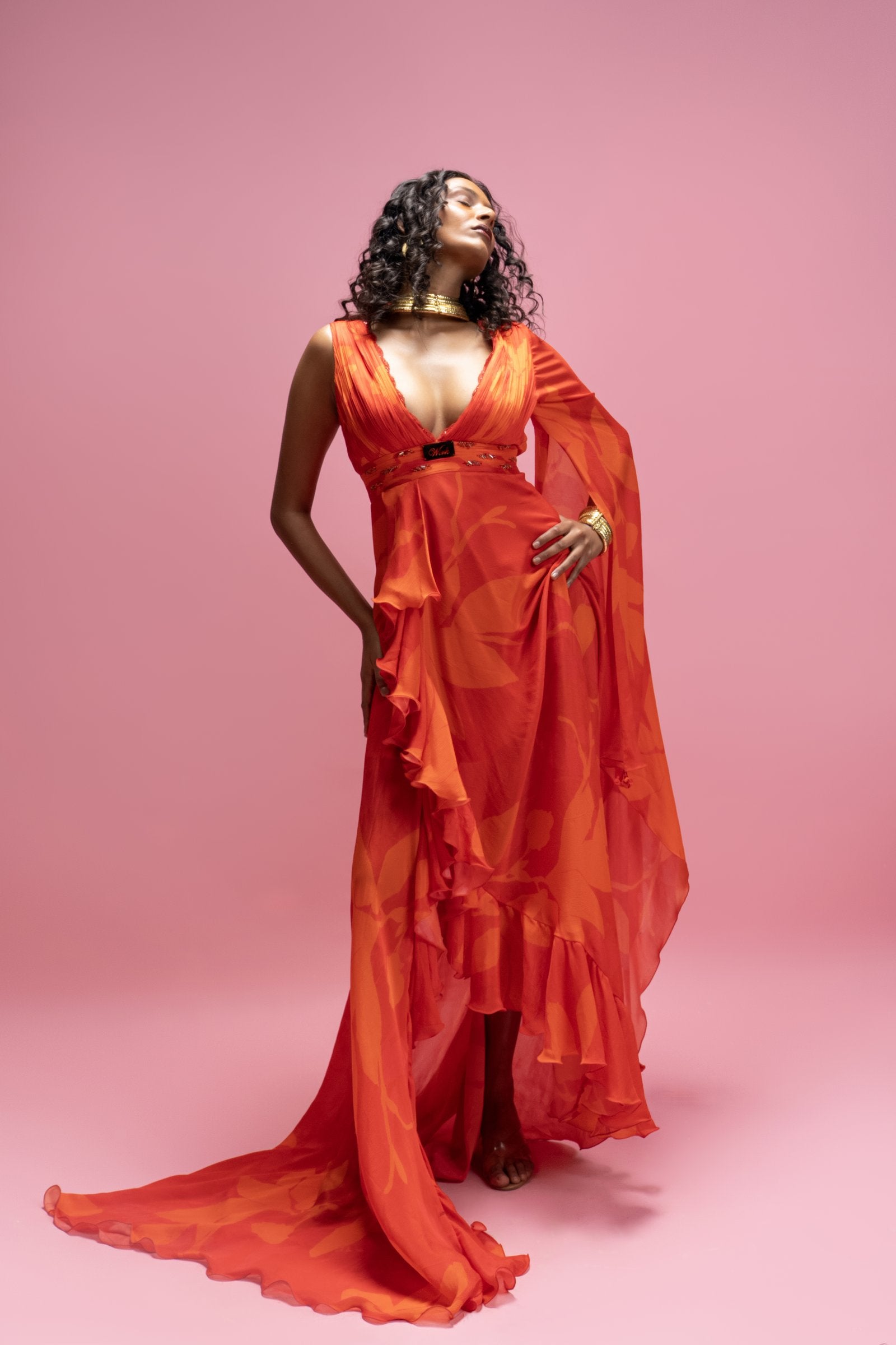 A statement maxi dress featuring a hand-draped construction that creates expansive movement with high slit. resort wear by mandira wirk
