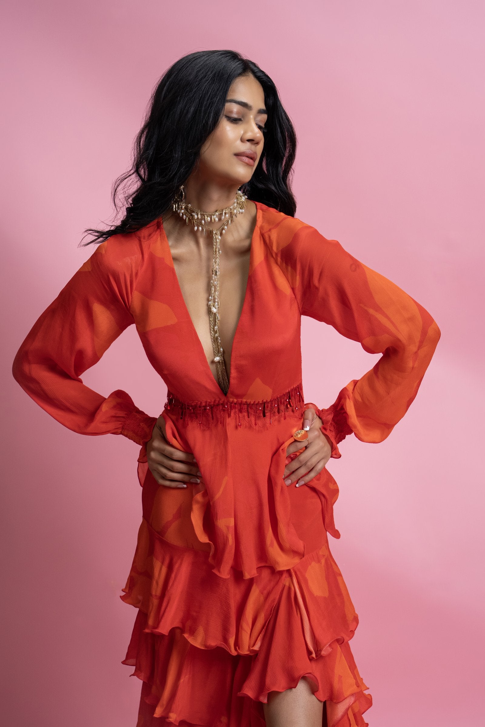 A tiered maxi dress featuring layered ruffles that build volume and movement through the silhouette
