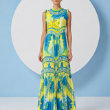 Woman wearing a colorful dress with a blue and white background