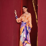 Model wearing Mandira Wirk Orange Eucalyptus co-ord set with off-shoulder printed top and draped trousers.