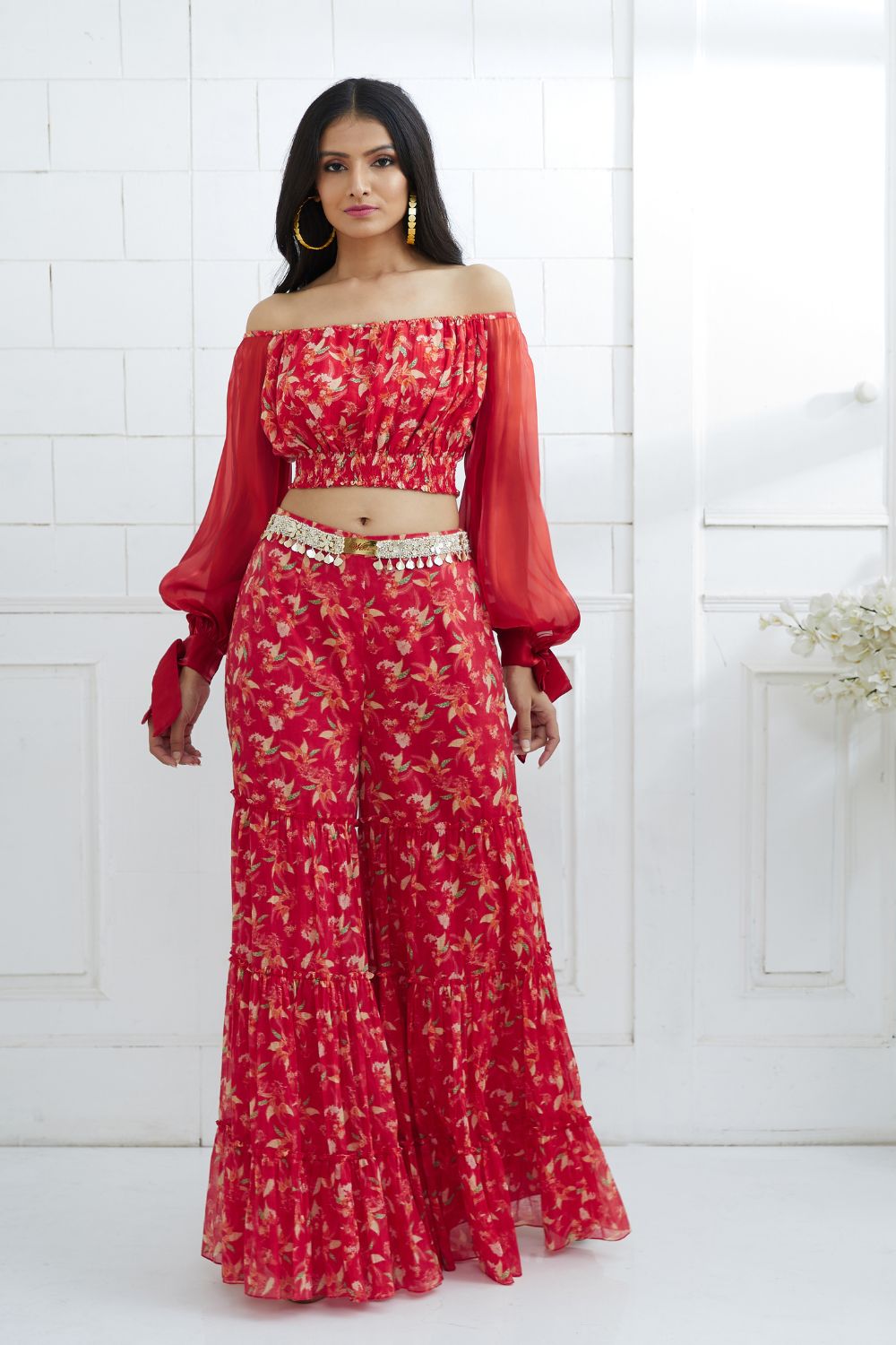RUSTY RED TIERED SHARARA PANT SET WITH A LONG PEPLUM STYLE SEQUIN WORK  KURTA TOP PAIRED WITH A MATCHING DUPATTA. - Seasons India