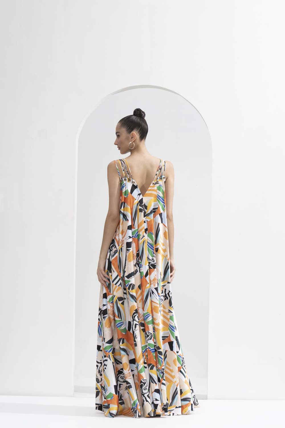 Yellow abstract satin printed long loose-fit dress with gold eyelet detailing.