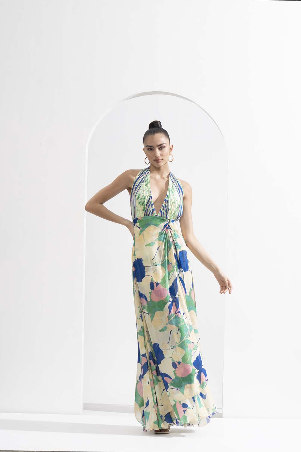 Mystic green chiffon placement printed draped halter neck dress with a silver accessory.
