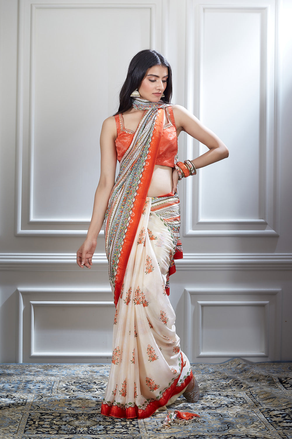 A printed saree paired with a hand embroidered printed blouse