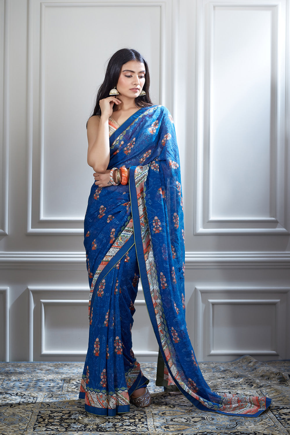 A printed saree paired with a printed and hand heigh lighted blouse.