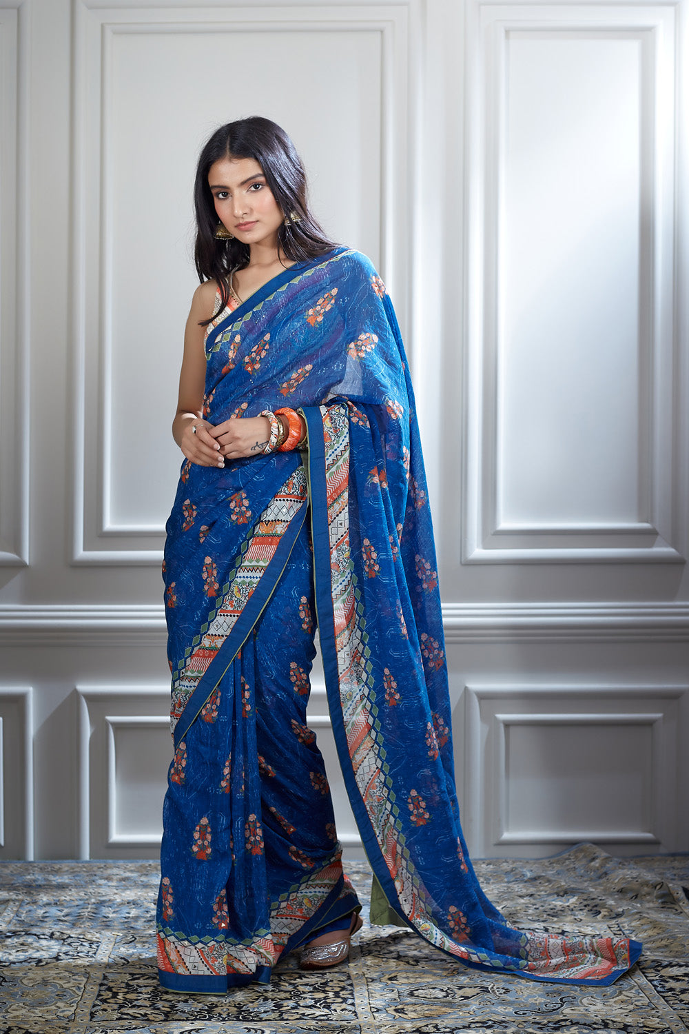 A printed saree paired with a printed and hand heigh lighted blouse.