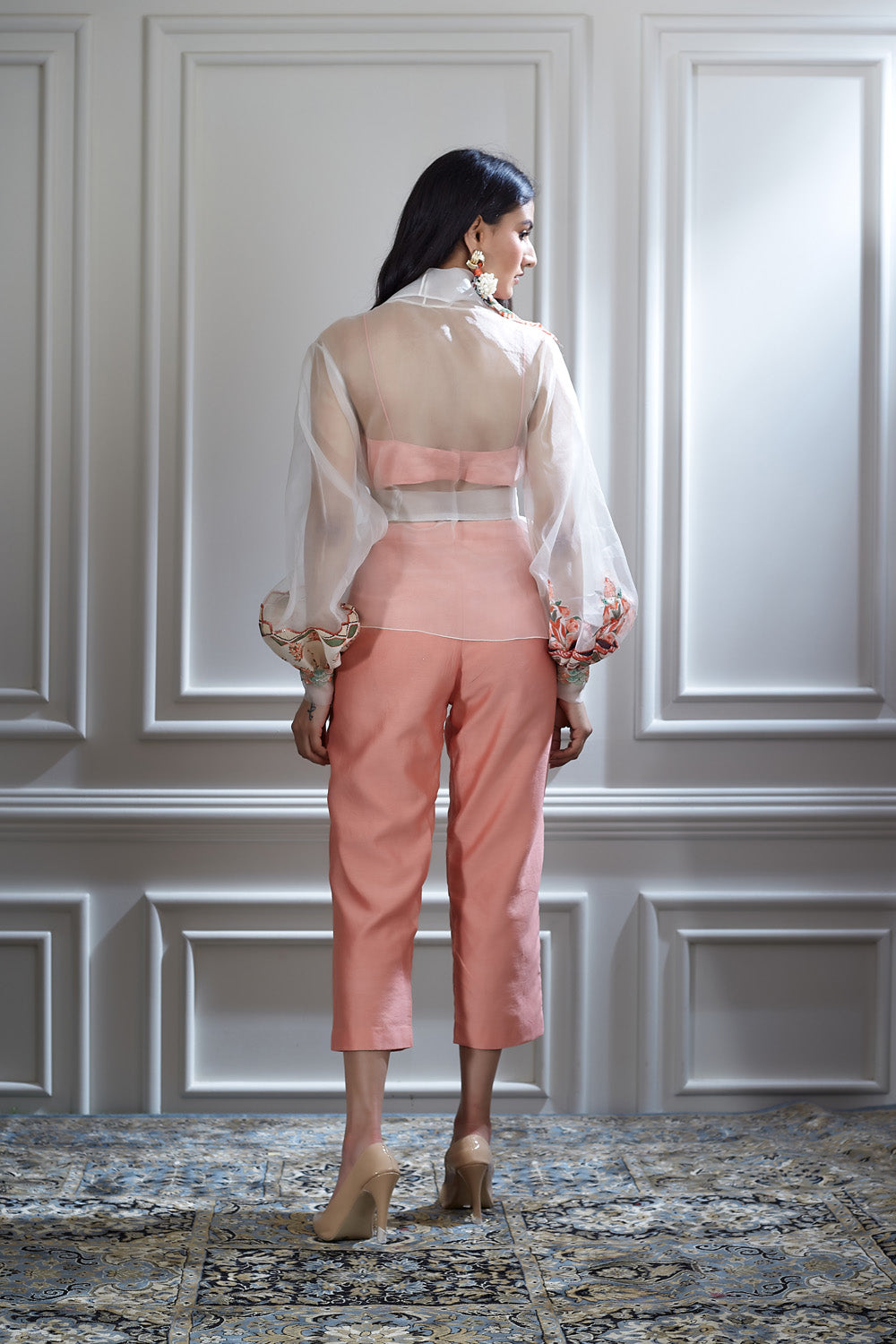 A soft organza jacket paired with a bustier and a crop pants
